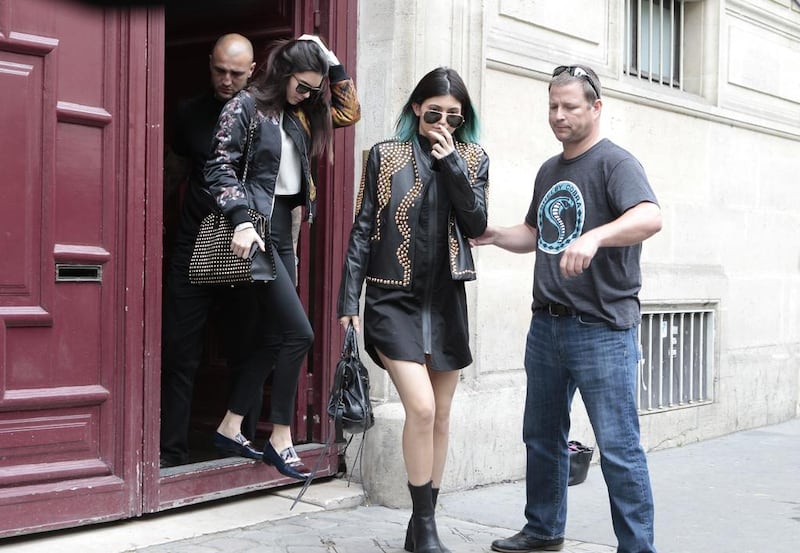Kendall Jenner, centre, and Kylie Jenner, leave Kanye West’s Paris apartment on May 20, 2014. . Jacques Brinon / AP photo
