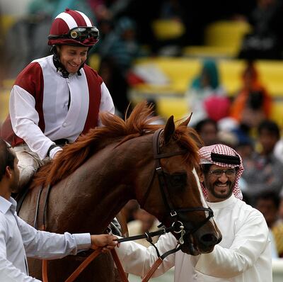 DUBAI, UNITED ARAB EMIRATES – Dec 18: Fathayer (USA) ridden by Royston Ffrench (jockey) after he won the 1800m race at Jebel Ali Race Course in Dubai. Also seen in the photo Ali Rashid Al Raihe (trainer on right side).  (Pawan Singh / The National) For Sports. Story by Sarah
 *** Local Caption ***  PS1812- HORSE RACE05.jpg