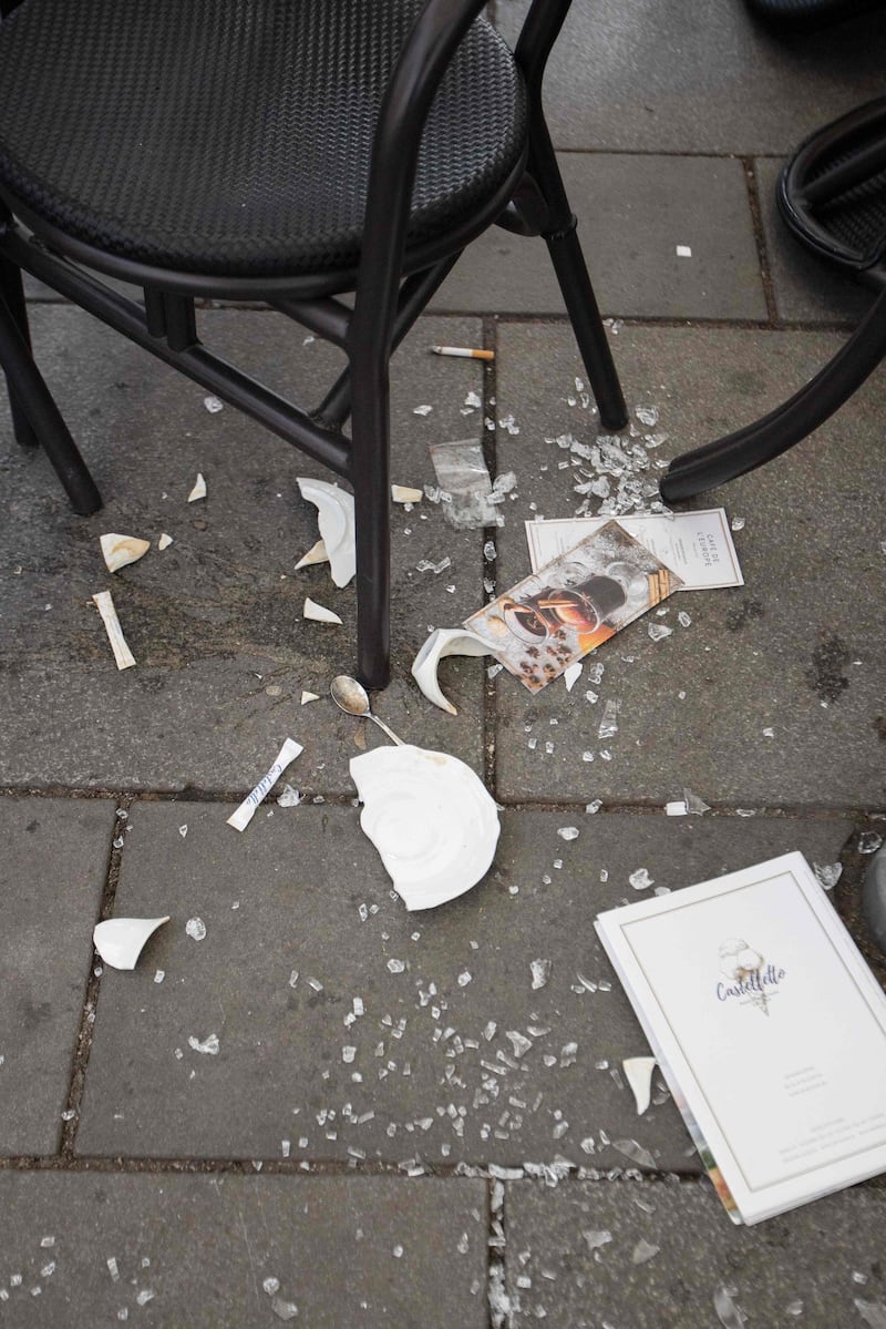 A broken plate lies on the ground next to chairs and tables of a cafe near Stephansplatz in Vienna after a shooting at several locations across central Vienna.  AFP