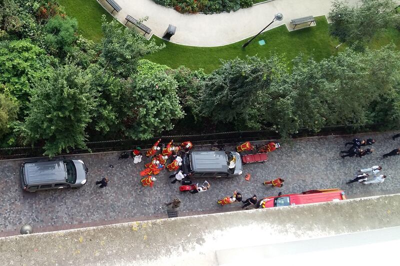 Officials and rescuers gather near vehicles after a car slammed into soldiers on patrol in Levallois-Perret, outside Paris. Thierry Chappe.