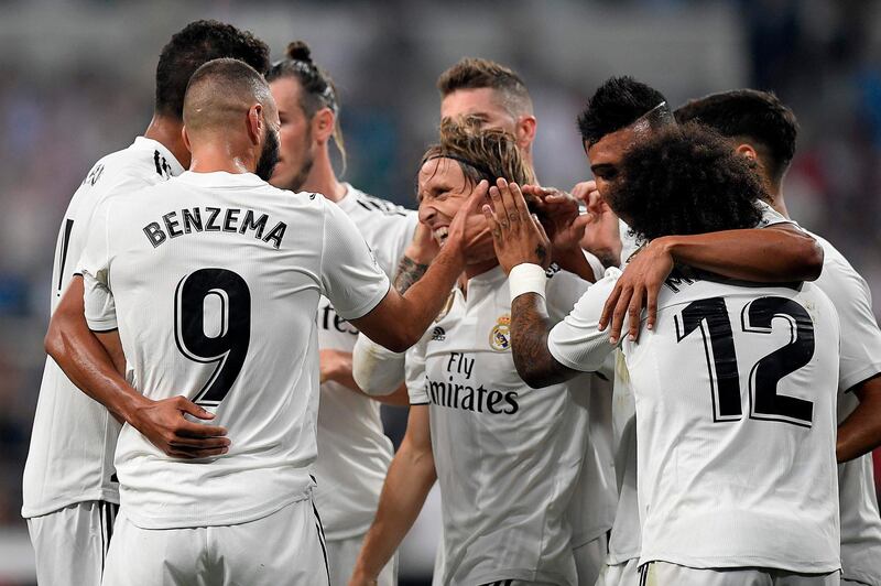 Karim Benzema celebrates with teammates after scoring Real Madrid's third goal. AFP