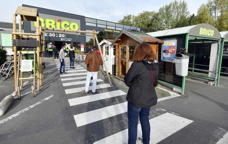 BELGIUM: Customers wait in line outside a Brico hardware store in Brussels, on April 18, 2020, on the first day of it's re-opening. From April 18, onwards gardening and hardware stores are allowed to receive costumers, as Belgium is in its fifth week of lockdown to stop the spread of coronavirus. AFP