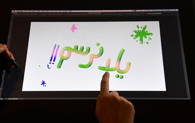 Artist Reem Ali Adeeb points to the words "Let's Draw" in Arabic while working in her studio apartment in Los Angeles, California on April 29, 2020, where she is developing online tutorials in Arabic for children about art, including drawing and reading. It was during a phone conversation with her sister back in Qatar that the idea clicked for Hollywood animation artist Reem Ali Adeeb. Like other regions across the world, young children in the Middle East were confined at home because of the COVID-19 pandemic, but there was not nearly enough original content online in Arabic as far as fun tutorials and activities to keep them entertained. / AFP / Frederic J. BROWN
