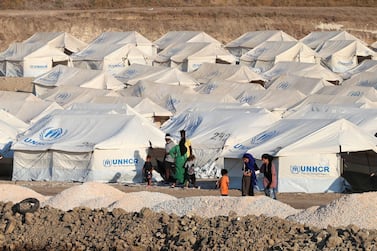 Refugees from the destroyed camp of Moria are seen at the new temporary camp, on the island of Lesbos, Greece, September 13, 2020. Reuters