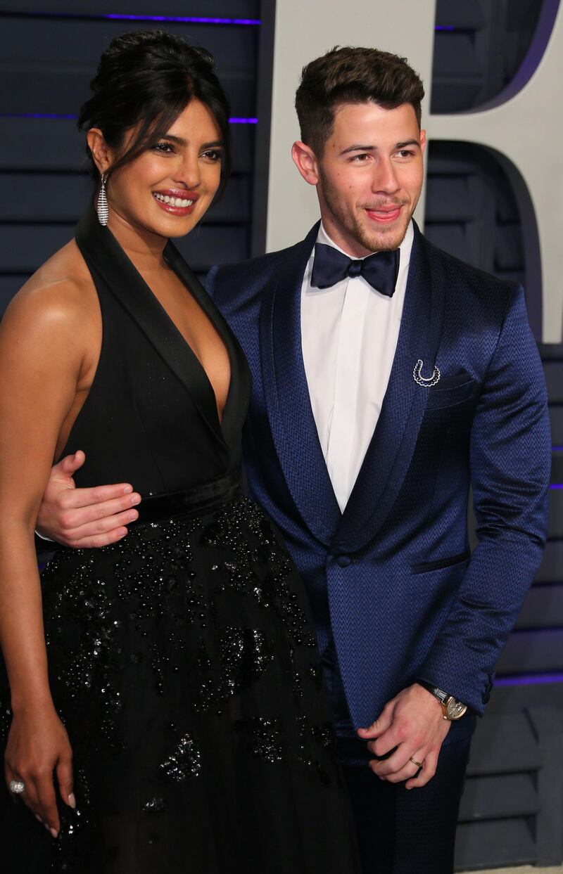 Priyanka Chopra in Elie Saab and Nick Jonas arrive at the 2019 Vanity Fair Oscar Party. AFP