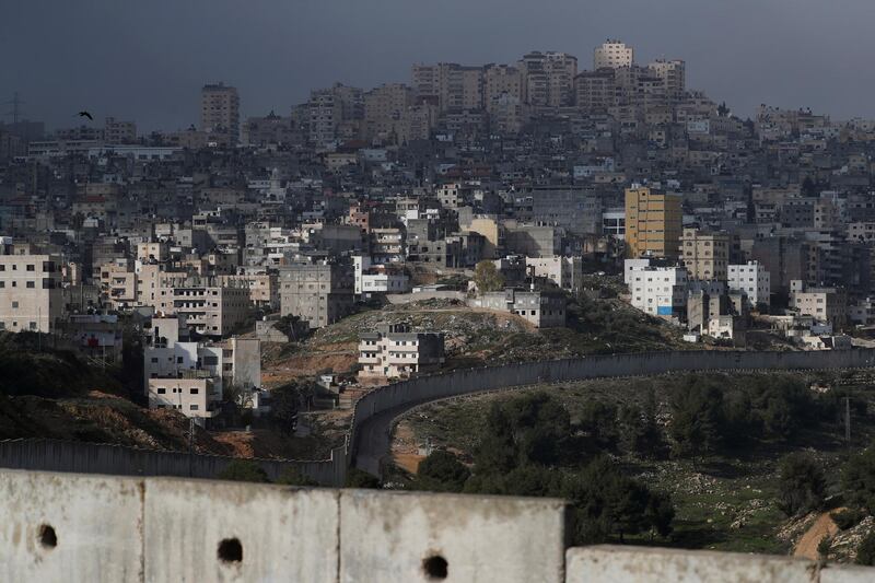 The Shuafat refugee camp in East Jerusalem is seen behind the Israeli barrier, in an area Israel annexed to Jerusalem after capturing it in the 1967 Middle East war January 29, 2020. REUTERS/Ammar Awad