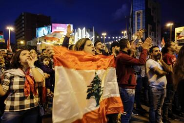 Lebanese anti-government demonstrators wave flags and shout slogans during a demonstration in Tripoli's Al Nour Square. AFP