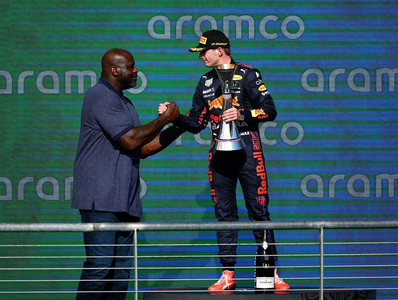 Race winner Max Verstappen on the podium with NBA legend Shaquille O'Neal. AFP