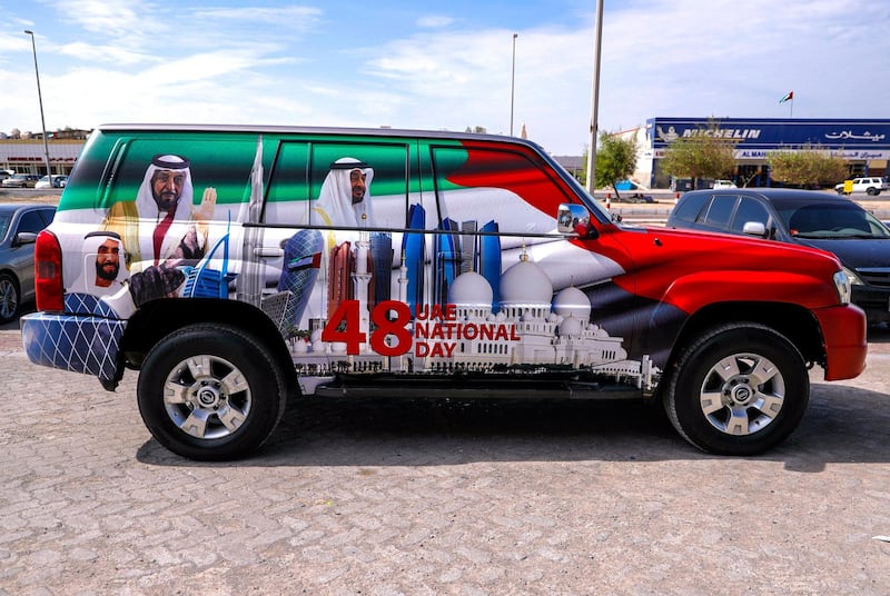 Abu Dhabi, United Arab Emirates, November 25, 2019.  
  Auto accessory and detailing shops at Musaffah M-2 area who decorate cars for  UAE National Day.
Target Care Care full body wraps a car with the UAE National Day theme starting at AED 2K.  It takes four hours labor done by a 4 man team.
Victor Besa / The National
Section:  NA
Reporter: