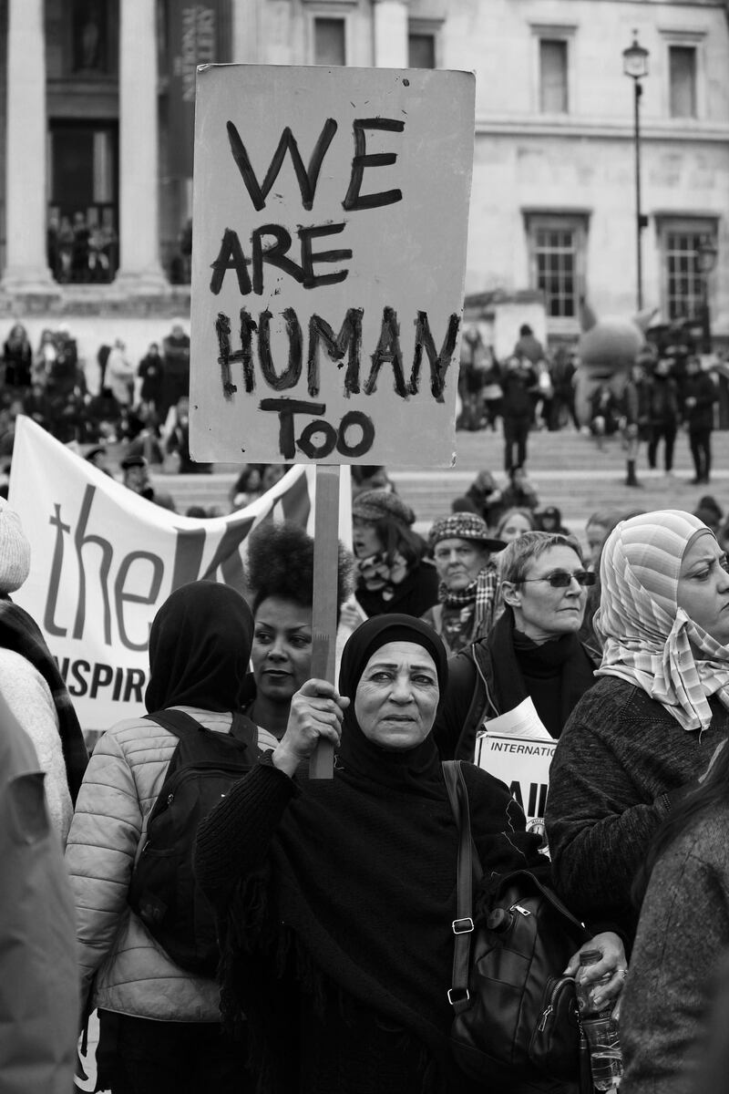 Shortlisted: 'We are Human Too' by Syed Jazib Ali. A Palestinian woman holding a placard saying "We are human too" at the 'Million Women Rise March' in London on 7th March 2020.