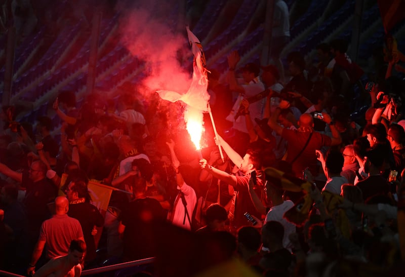 Roma fans celebrate with flares after winning the Europa Conference League. Reuters