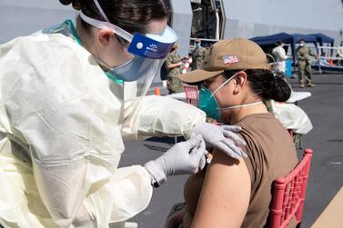 A United States Navy officer from the amphibious ship USS San Diego (LPD 22) receives a vaccine against Coronavirus (COVID-19) at the navy port in Manama, Bahrain in this picture taken February 26, 2021 and released by U.S Navy on February 27, 2021. Brandon Woods/U.S. Navy/Handout via REUTERS ATTENTION EDITORS- THIS IMAGE HAS BEEN SUPPLIED BY A THIRD PARTY.