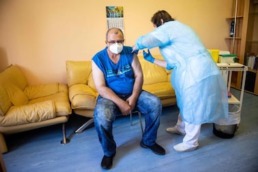 A man is vaccinated against Covid-19 in Slovakia, but an imbalance of available doses is up for discussion among world leaders. AFP