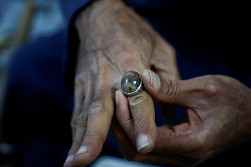 Mr Suaan displays a gemstone which he has mounted on a ring