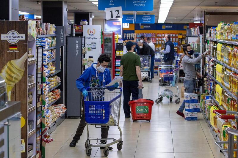 Masked customers and employees are seen at supermarket in Amman, Jordan.  EPA