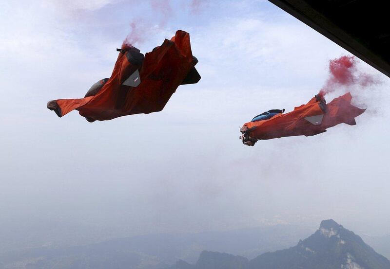 Wingsuit flying athletes shown during a jump above China's Tianmen Mountain on Sunday during the Red Bull wingsuit flying China Grand Prix. China Daily / Reuters