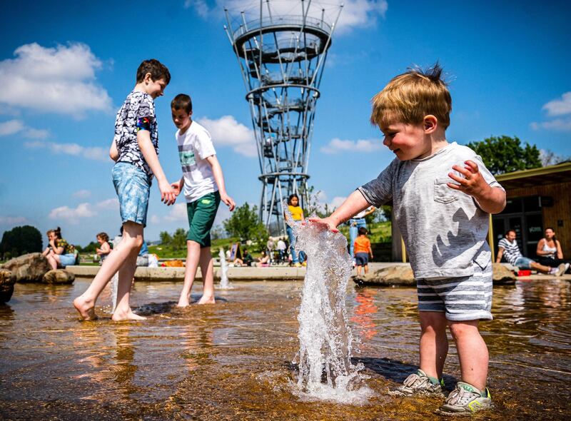 Children enjoy the sunny weather in a park in Tilburg, the Netherlands. EPA