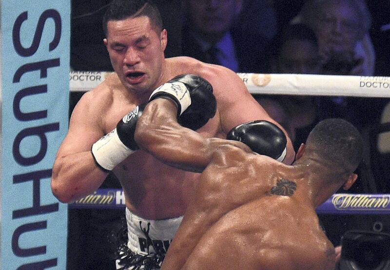 Joseph Parker (L) of New Zealand absorbs a left from Anthony Joshua (R) of Great Britain during their heavyweight unification bout at Principality Stadium in Cardiff, March 31, 2018. (Photo by Oli SCARFF / AFP)