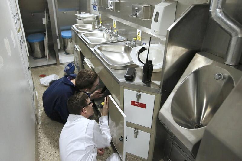 Workers install sinks in a crew bathroom onboard HMS Artful as it approaches completion at BAE Systems' shipyard in northern England. Phil Noble / Reuters