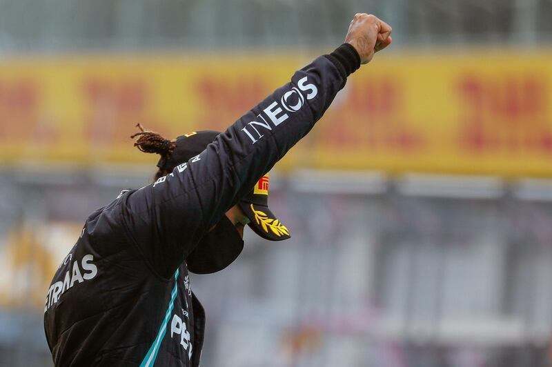 Lewis Hamilton raises a fist on the podium after winning the Styrian Grand Prix. AFP