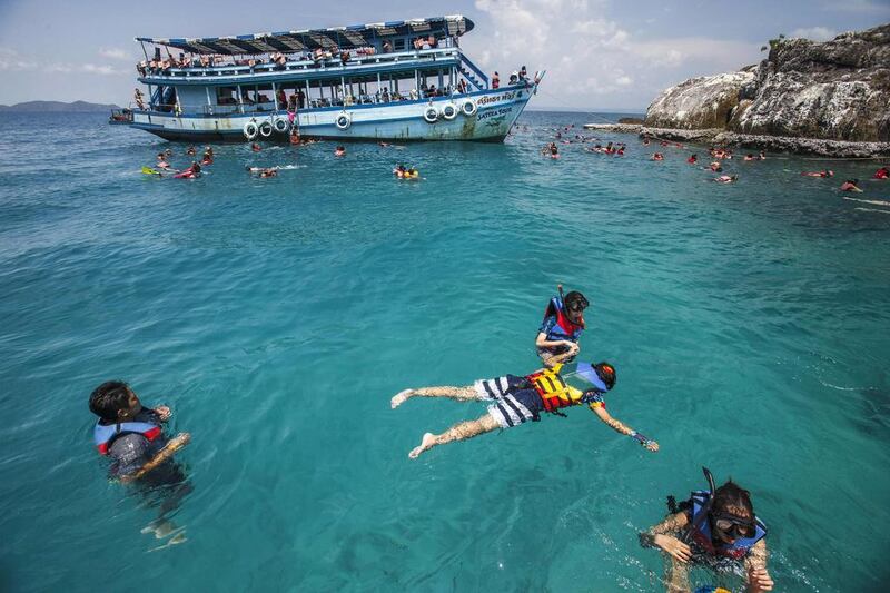 Tourists swim in clear water near Kut island, eastern Thailand. Athit Perawongmetha / Reuters