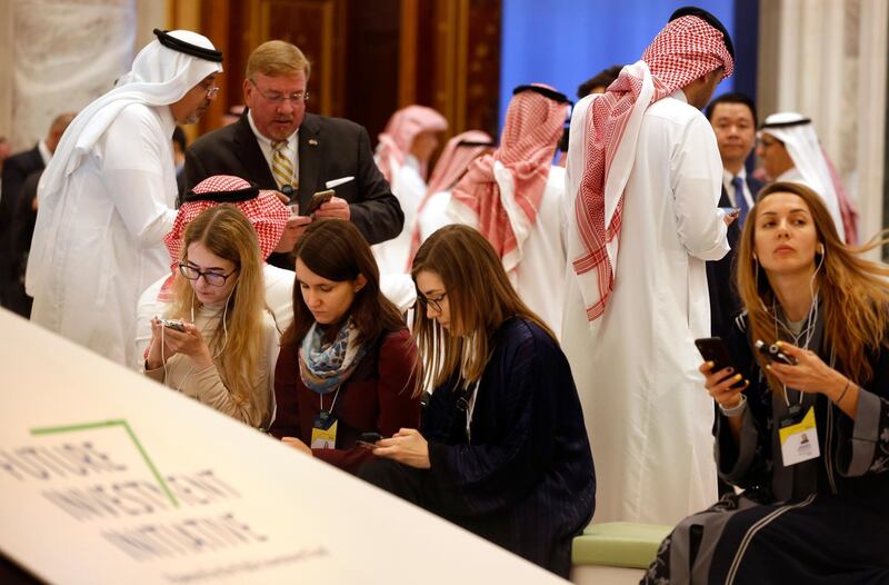 Participants of the Future Investment Initiative forum, "FII", read the news during the opening session in Riyadh, Saudi Arabia. The three-day forum, beginning on Tuesday, will host financiers, governments, and industry leaders who would discuss global trade and explore the trends, opportunities and challenges shaping the global investment landscape over the coming decades. AP Photo