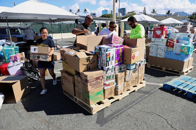 Hawaii stevedores and other volunteers prepare donations in Hawaii. Reuters