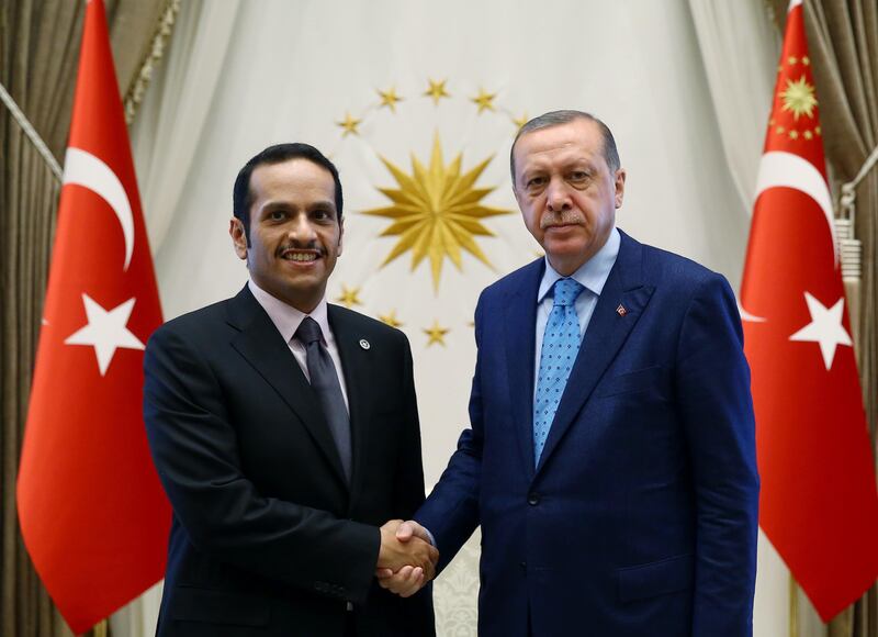 Turkey's President Recep Tayyip Erdogan, right, shakes hands with Qatar's Foreign Minister Sheikh Mohammed bin Abdulrahman Al Thani prior to their meeting in Ankara, Friday, July 14, 2017. Al Thani told reporters in Ankara Friday that Qatar would continue to work with the United States and Kuwait to end the standoff with its four Arab neighbours.(Presidency Press Service/Pool Photo via AP)