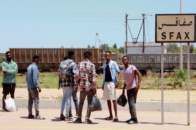 Migrants waiting for a train as they flee to Tunis amid unrest in Sfax after a Tunisian man was stabbed in an altercation with migrants on July 3. AFP