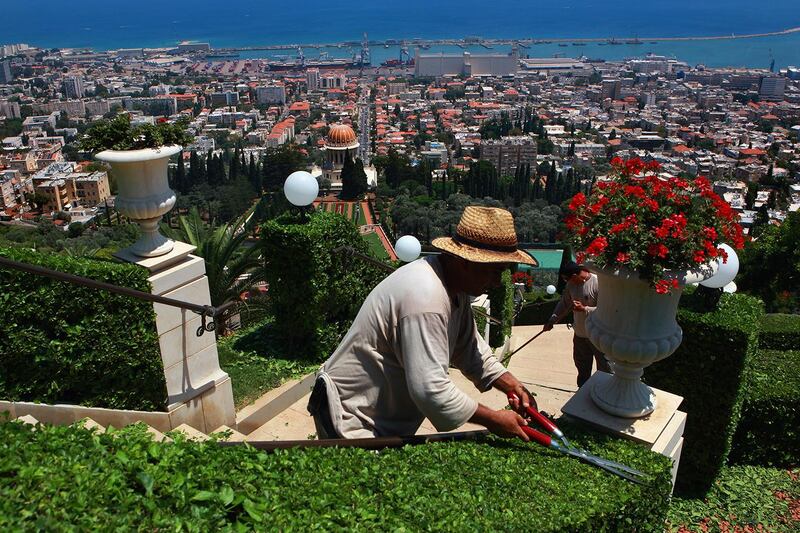 HAIFA, ISRAEL - JULY 14:  Gardeners tend to one of the 18 terraced gardens that flank the golden-domed Shrine of the Bab July 14, 2008 in Haifa, Israel. The world spiritual center of the Bahai faith and resting place for the remains of their founder Bab, whose devotees number less than six million worldwide, was declared a World Heritage Site by UNESCO last week.  (Photo by David Silverman/Getty Images)