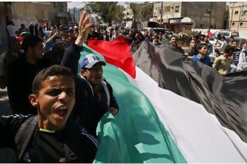 Palestinian demonstrators take part in a protest calling for Palestinian political unity between Gaza's Hamas rulers and the Fatah-dominated Palestinian Authority which rules from Ramallah. AFP PHOTO/SAID KHATIB Said Khatib / AFP Photo