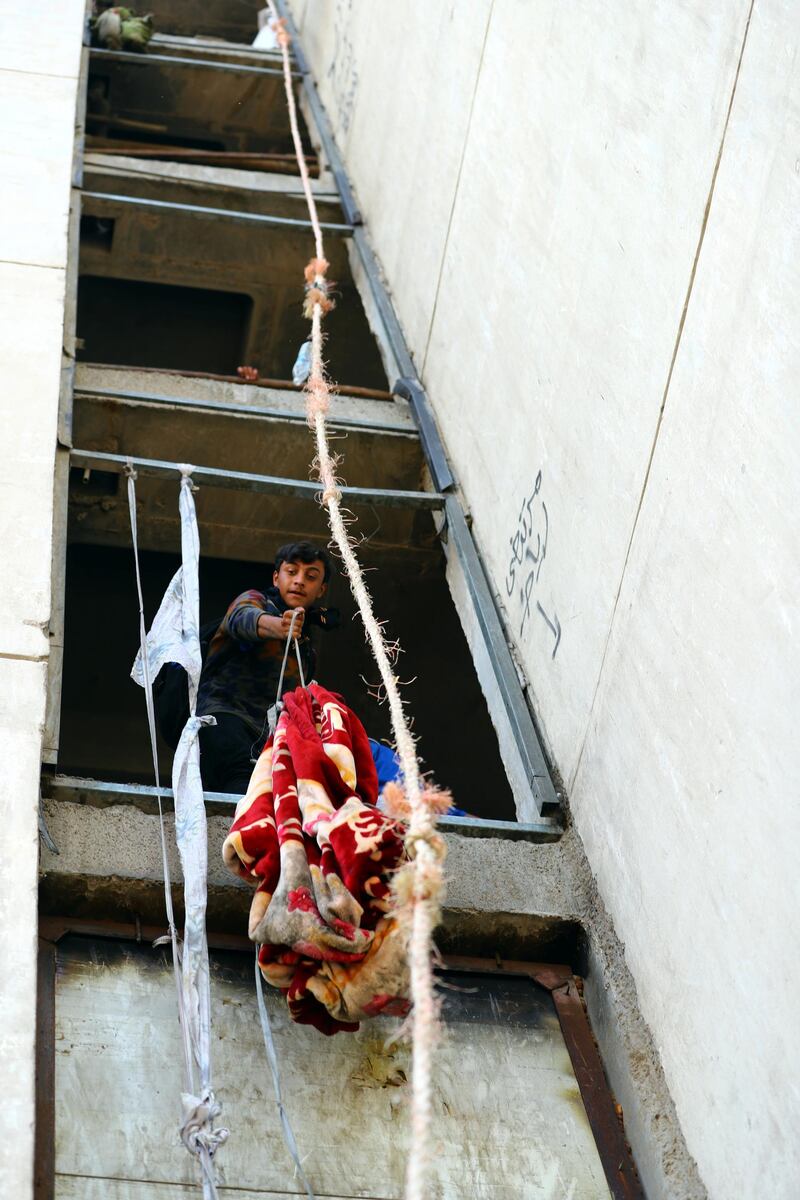 Iraqi demonstrators use blankets to supply food to their fellows inside the high-rise building. REUTERS