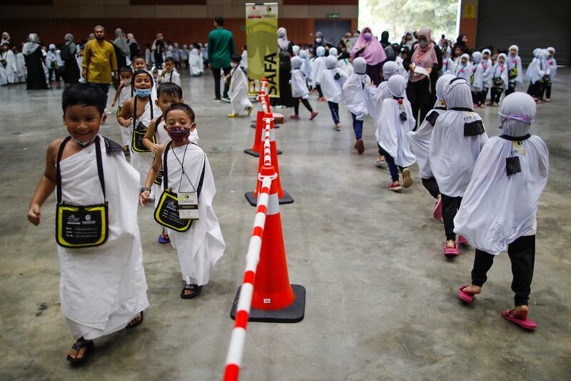 Children perform 'Sa'i', running or walking seven times between the hills of Safa and Marwah, located near the Kaaba, during Little Hajj 2022 in Malaysia.
