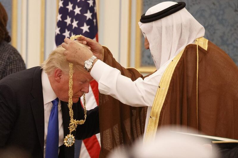 King Salman of Saudi Arabia presents Donald Trump with the highest civilian honor, the Collar of Abdulaziz Al Saud, at the Royal Court Palace, in Riyadh. Evan Vucci / AP Photo