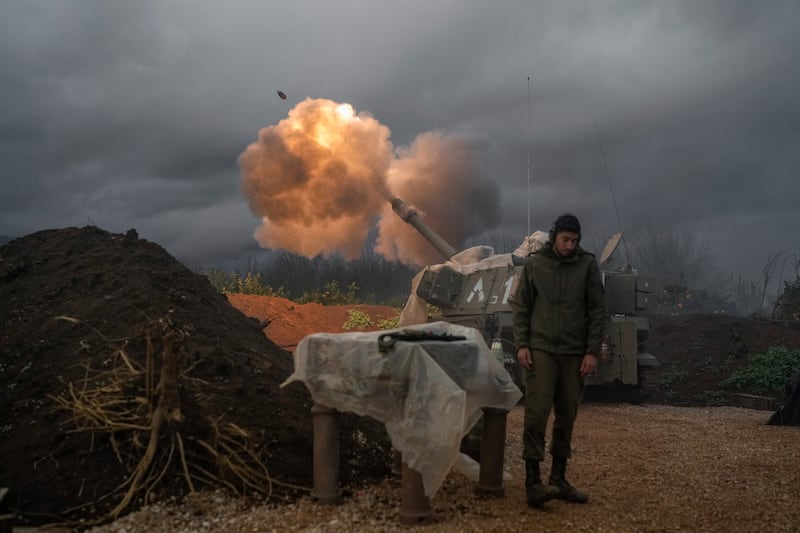 An Israeli mobile artillery unit fires a shell from northern Israel towards Lebanon on January 11. Thousands of people on both sides of the border have fled their homes due to the fighting. AP