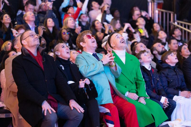 Sir Elton and husband David Furnish watch the fireworks display at the Saks Fifth Avenue holiday unveiling. Photo: BFA