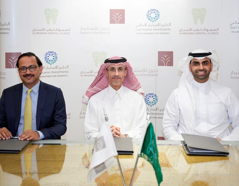 (L-R) Pankaj Gupta, co-chief executive at Gulf Islamic Investment; Tariq Al-Sudairy, chief executive of Jadwa Investment; and Mohammed Alhassan, co-chief executive at Gulf Islamic Investment during the signing of the Almeswak Dental Clinics deal. Photo: Almeswak Dental Clinics