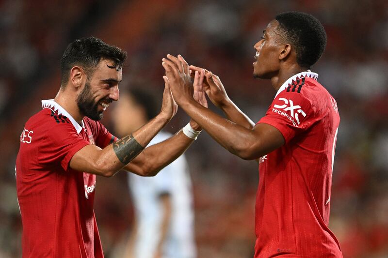 Manchester United's Anthony Martial, right, celebrates with midfielder Bruno Fernandes after scoring Manchester United's third goal. AFP