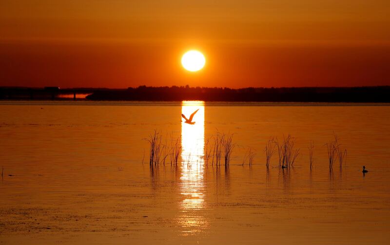 The rising sun illuminates the lake near the town of Vileika, Belarus.  Reuters