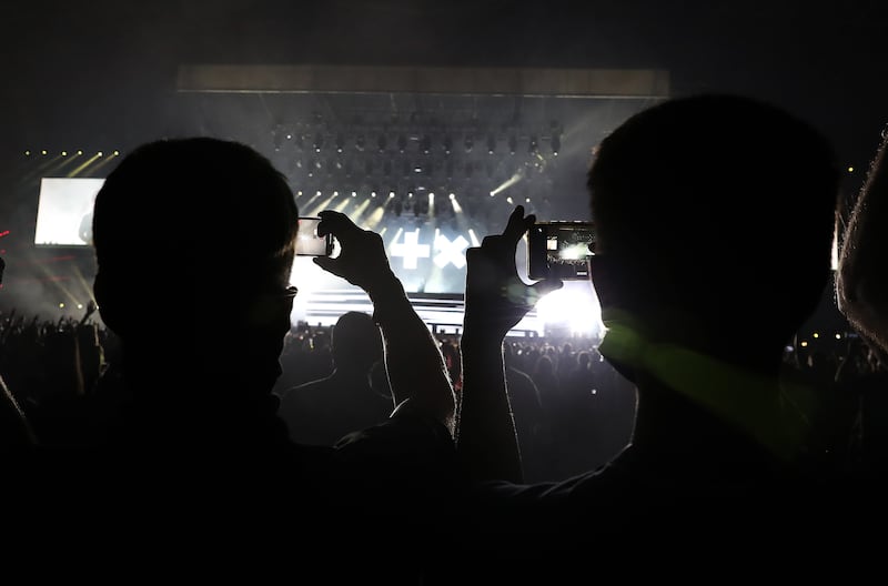 People recording the performance of DJ Martin Garrix during the F1 concert held at Etihad Park in Abu Dhabi. Pawan Singh/The National