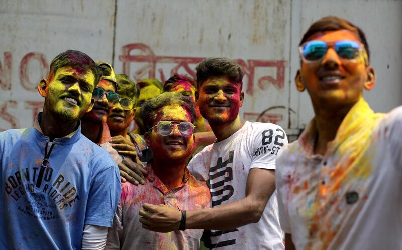 Tourists and locals apply color dust to each other as they celebrate Holi festival in Kolkata, Eastern India. EPA