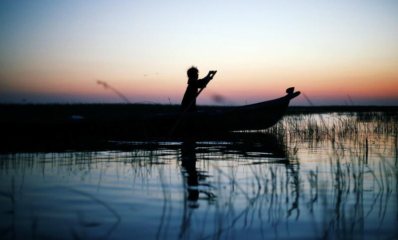 An Iraqi Marsh Arab girl paddles her boat at the Chebayesh marsh in Dhi Qar province, Iraq April 13, 2019.  Picture taken April 13, 2019. REUTERS/Thaier al-Sudani