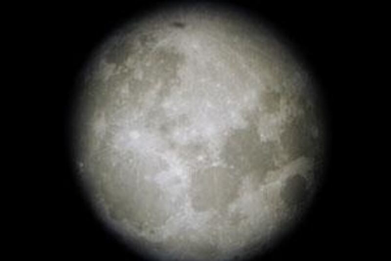 This photograph of the moon was shot with a digital camera through the eyepiece of a telescope set up at the Cheboygan County (Mich.) Marina on Tuesday night, Aug. 12, 2003. The full moon arrived on Monday, and the last quarter will be visible on Tuesday. A new moon will be in the skies on Aug. 27. In addition to the full moon, amateur astronomers enjoyed a meteor shower Tuesday night, as well as a clear view of the planet Mars, which is the closest planet to the Earth as it has been in tens of thousands of years. (AP Photo/Cheboygan Daily Tribune, Rich Adams)