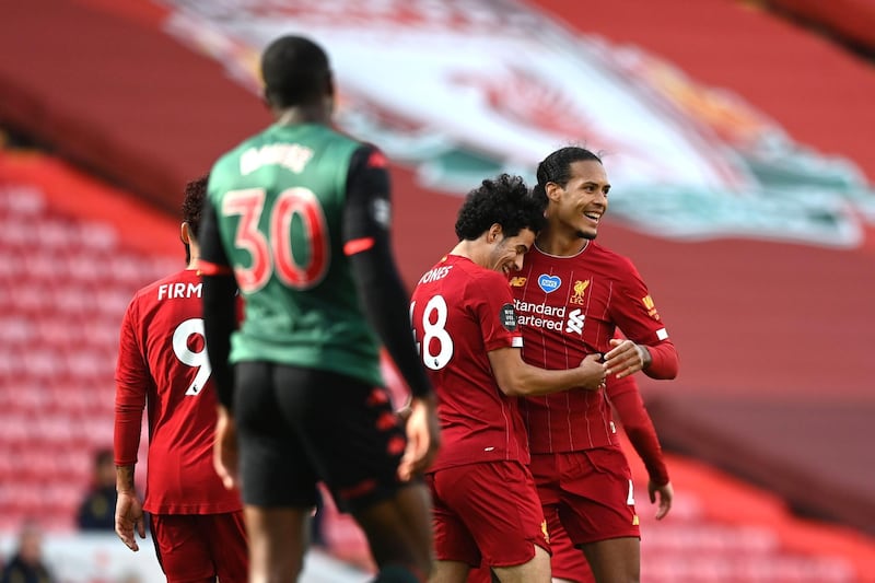 LIVERPOOL, ENGLAND - JULY 05: Curtis Jones of Liverpool celebrates with teammate Virgil van Dijk after scoring his team's second goal during the Premier League match between Liverpool FC and Aston Villa at Anfield on July 05, 2020 in Liverpool, England.Football Stadiums around Europe remain empty due to the Coronavirus Pandemic as Government social distancing laws prohibit fans inside venues resulting in games being played behind closed doors. (Photo by Shaun Botterill/Getty Images)