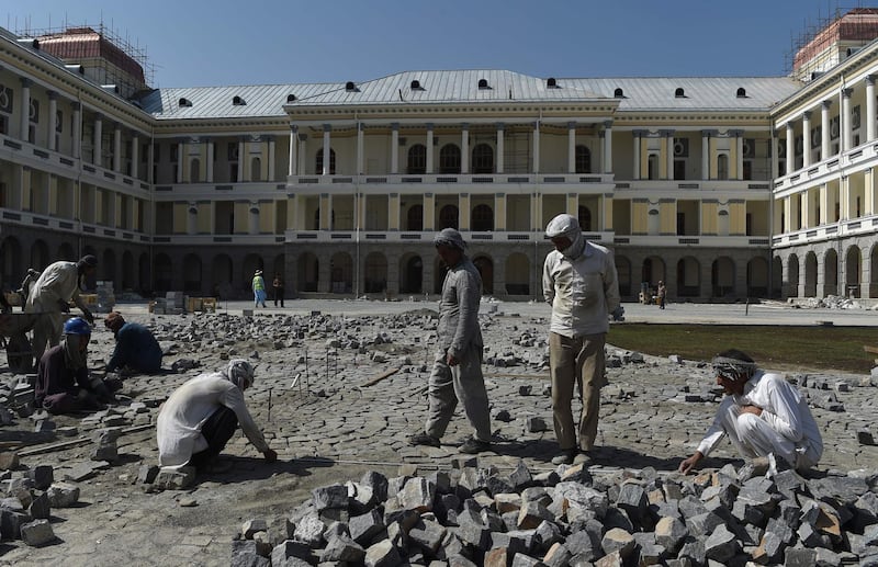 Afghan labourers work on the grounds of the palace on August 8, 2019, just days before its scheduled reopening by President Ashraf Ghani. AFP