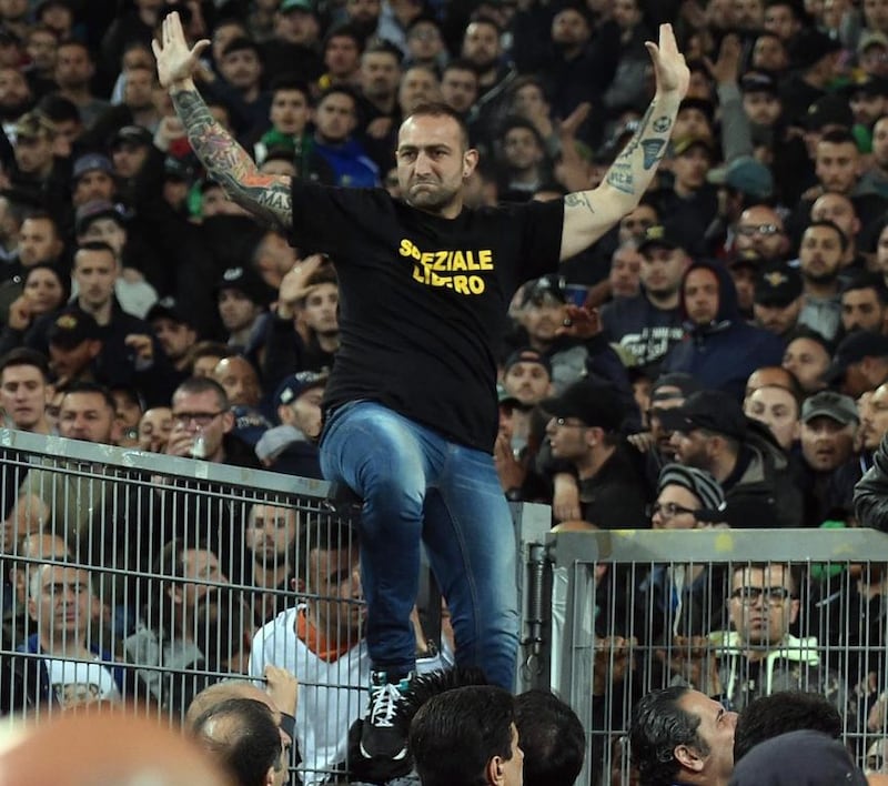 Gennaro de Tommaso, the leader of SSC Napoli 'Curva A' supporters, wears a shirt reading 'Speziale Libero' as he sits on the railing prior the Italy Cup final soccer match ACF Fiorentina vs SSC Napoli at Olimpico stadium in Rome, Italy, 03 May 2014. According to news reports on 04 May, the shirt apparently referred to a jailed Italian soccer fan who killed a police officer by throwing a block of concrete outside a soccer match in 2007. Ettore Ferrari / EPA