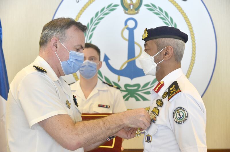 Rear Admiral Sheikh Saeed bin Hamdan, right, is presented with the Legion of Honour (Officer) by Admiral Pierre Vandier, chief of staff of the French Navy, during his visit to the UAE. Wam