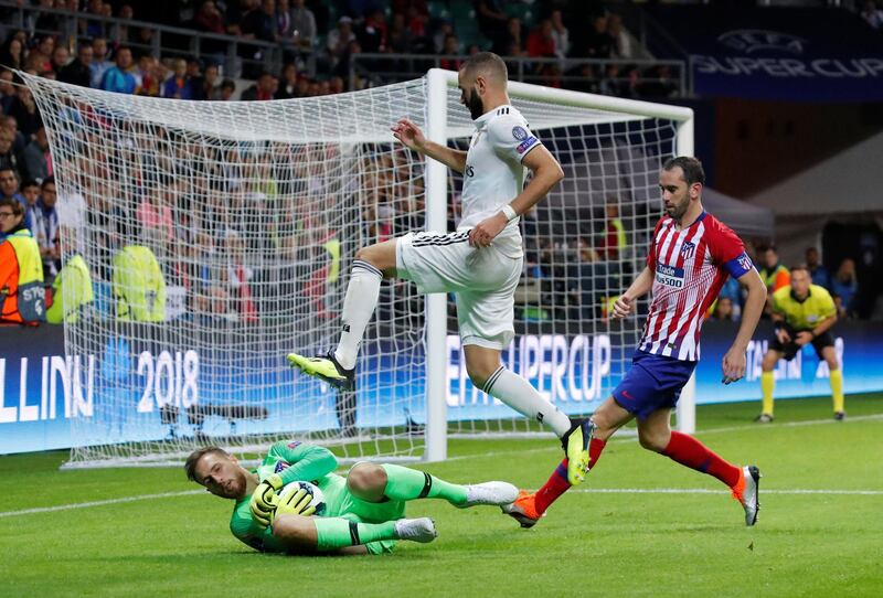 Atletico's goalkeeper Jan Oblak in action with Real's Karim Benzema. Reuters
