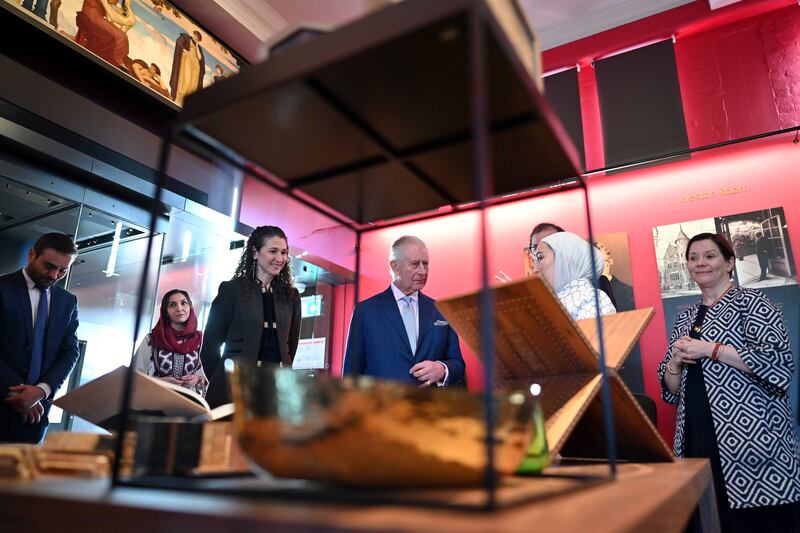 The monarch is shown a collection of artworks from Syria, Jordan and Afghanistan. Getty Images