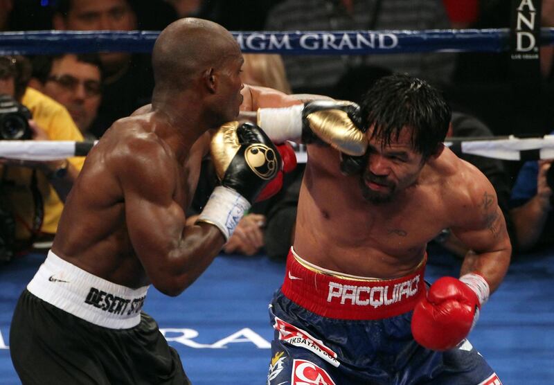 LAS VEGAS, NV - JUNE 09:  (L-R) Timothy Bradley lands a left to the head of Manny Pacquiao during their WBO welterweight title fight at MGM Grand Garden Arena on June 9, 2012 in Las Vegas, Nevada.  (Photo by Jeff Bottari/Getty Images)